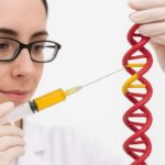 scientist working on CRISPR-edited immune cells for GI cancer treatment in a lab setting
